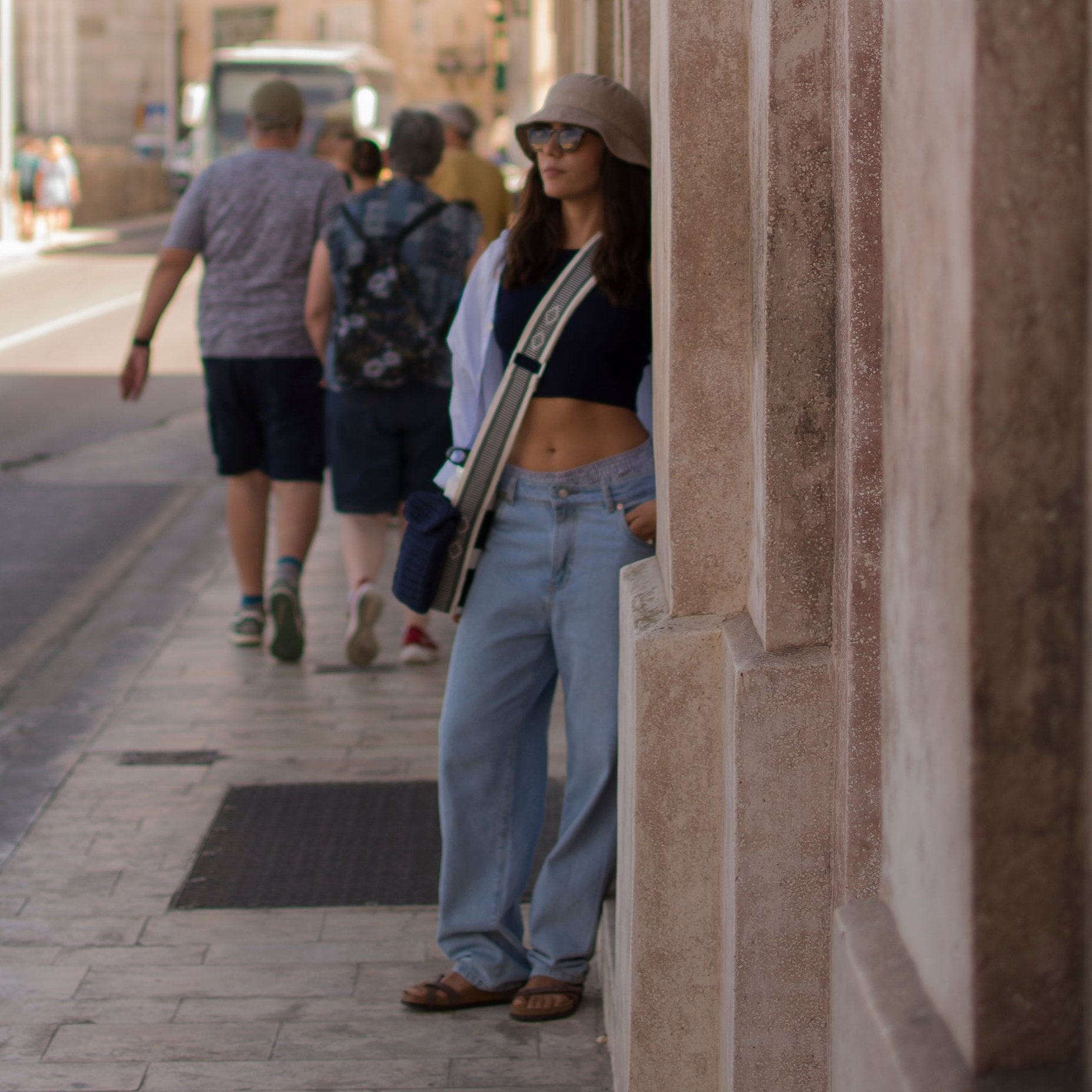 a beautiful woman using a handmade bag strap