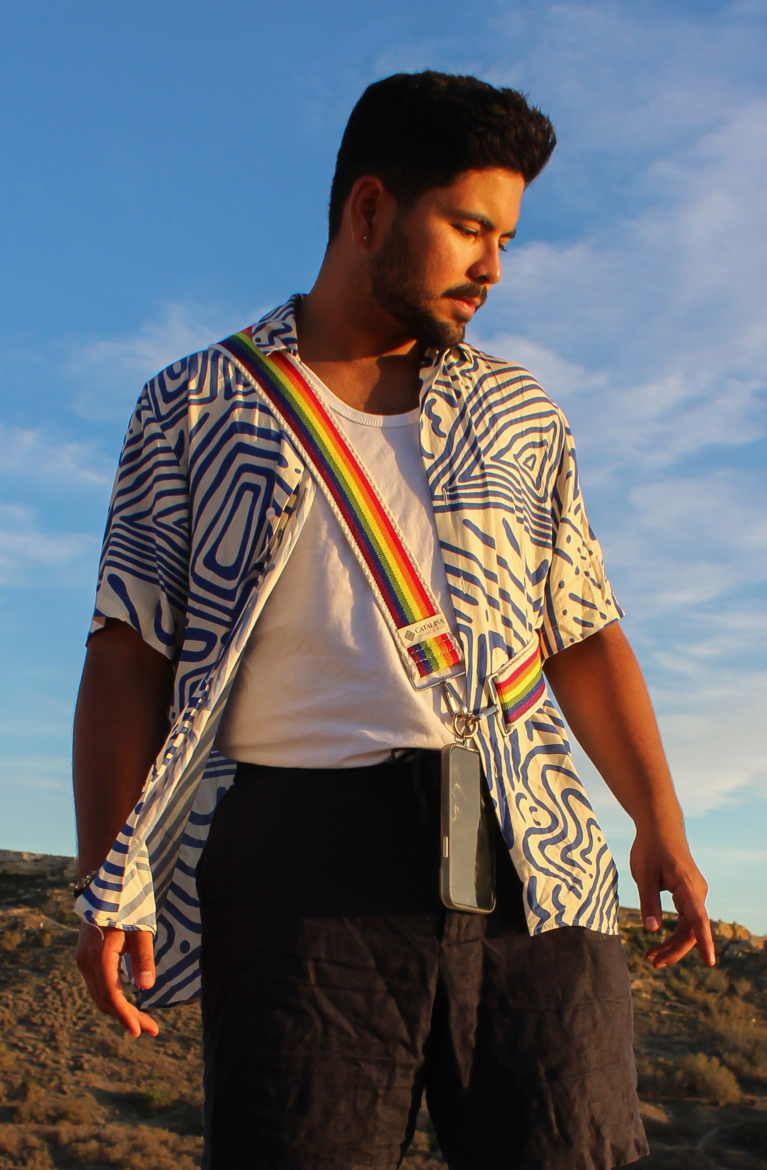 a beautiful man using our pride handbag strap