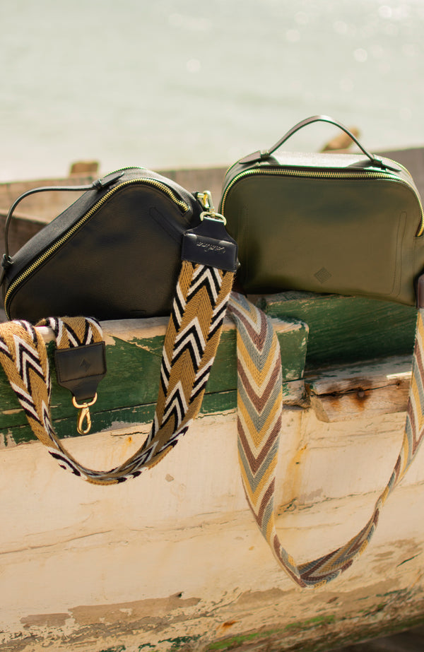 Close up shot of the Urban Safari handbag and strap in two colour variants, Olive and Black