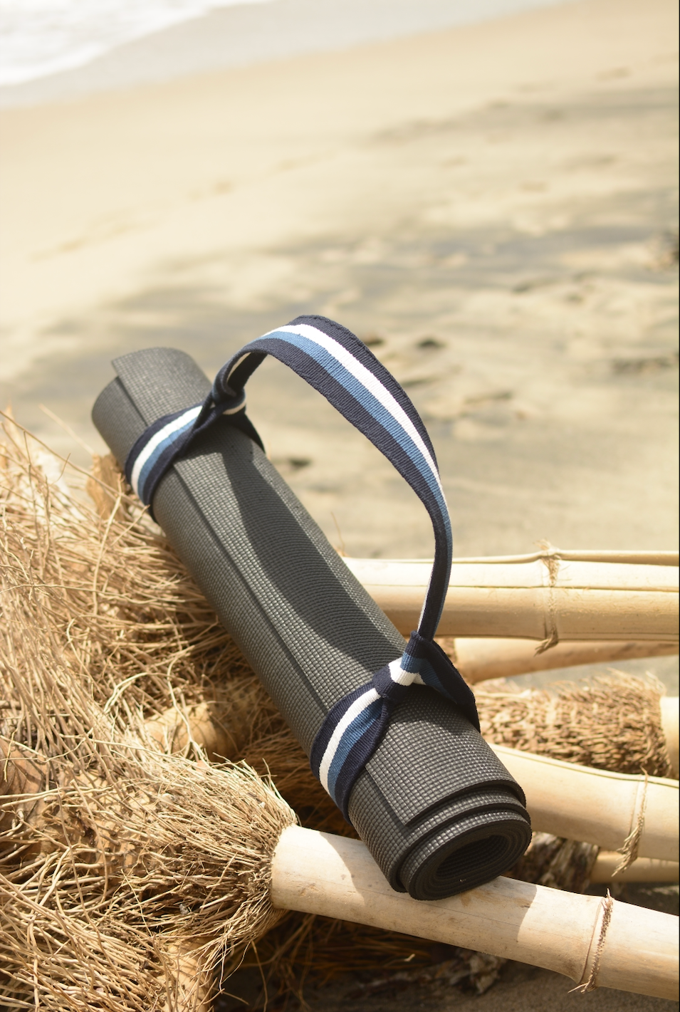 Yoga mat and Catalina strap with a blurred beach background